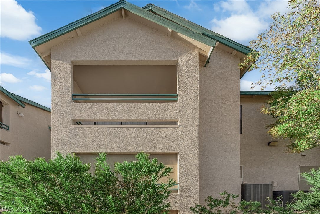 5111 Lindell Road, #202, Las Vegas, NV 89118 Multi-level stucco exterior pairs perfectly with mature landscaping under clear blue skies.