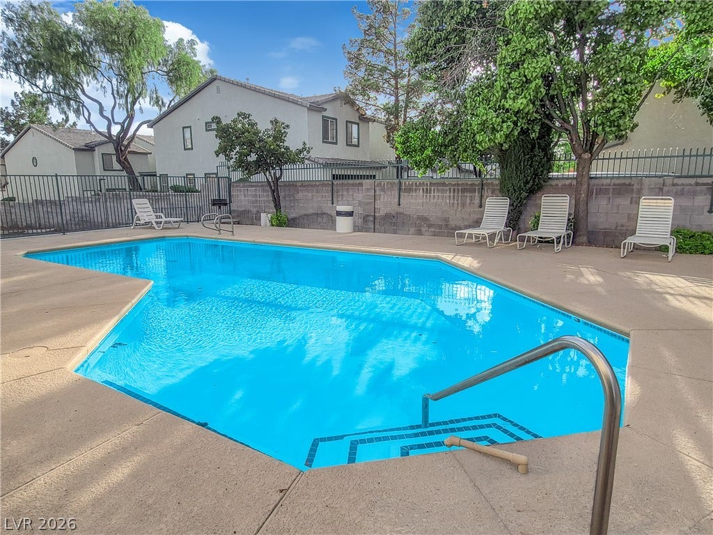 5111 Lindell Road, #202, Las Vegas, NV 89118 A sparkling in-ground pool is surrounded by a spacious concrete patio and secure fencing.