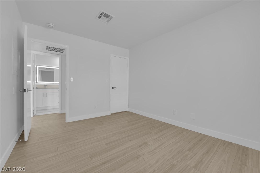 5111 Lindell Road, #202, Las Vegas, NV 89118 Smooth wood floors and crisp white walls define this versatile bedroom suite with bathroom access.