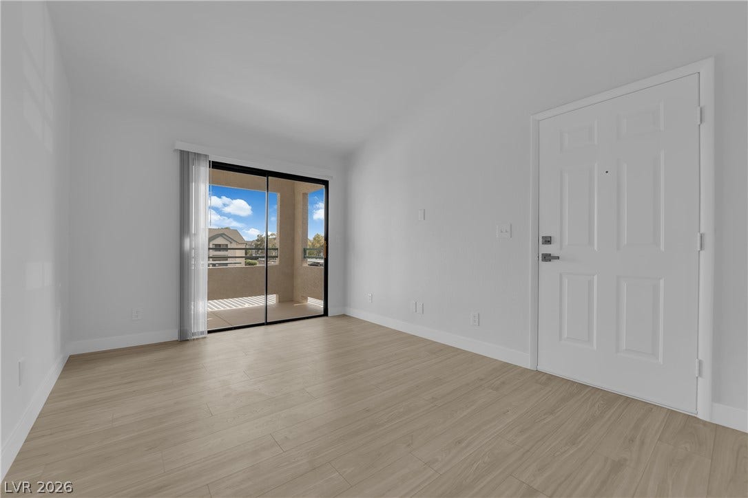 5111 Lindell Road, #202, Las Vegas, NV 89118 A sliding glass door opens to a private balcony, highlighting this modern open living space.