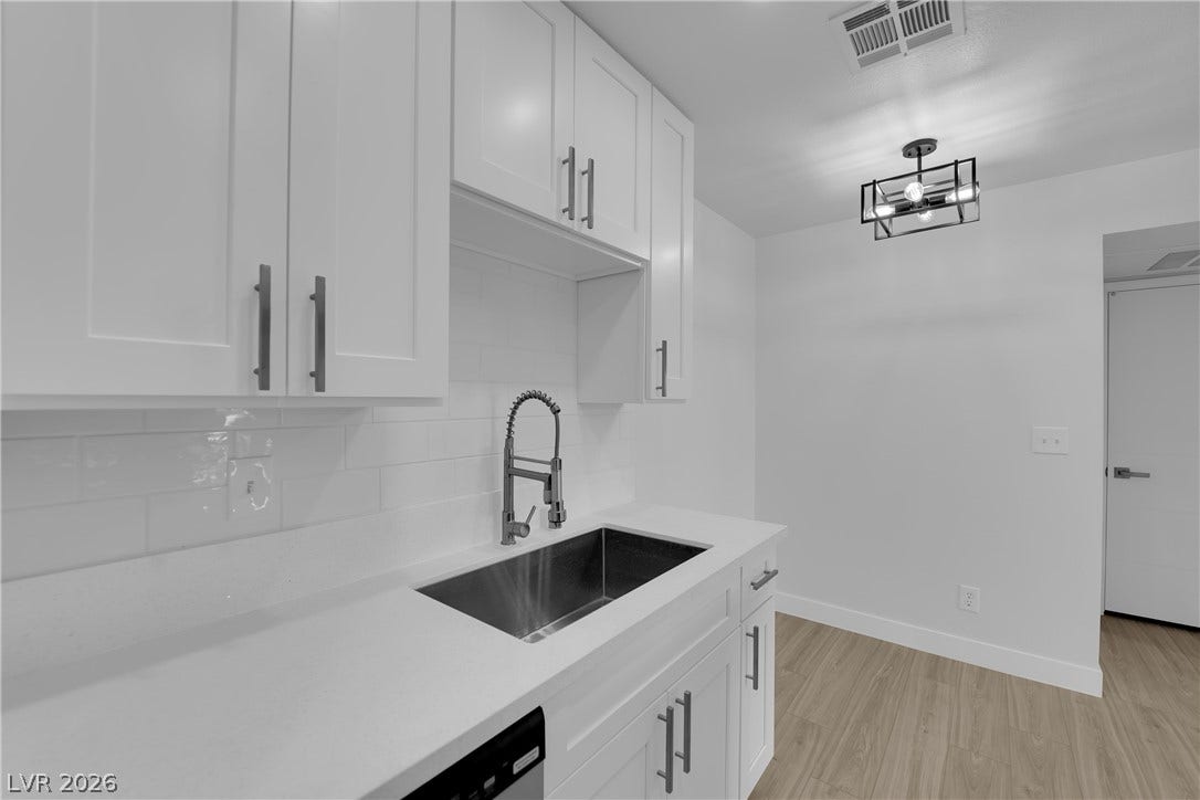 5111 Lindell Road, #202, Las Vegas, NV 89118 Crisp cabinetry and streamlined countertops define this modern, efficient kitchen space.
