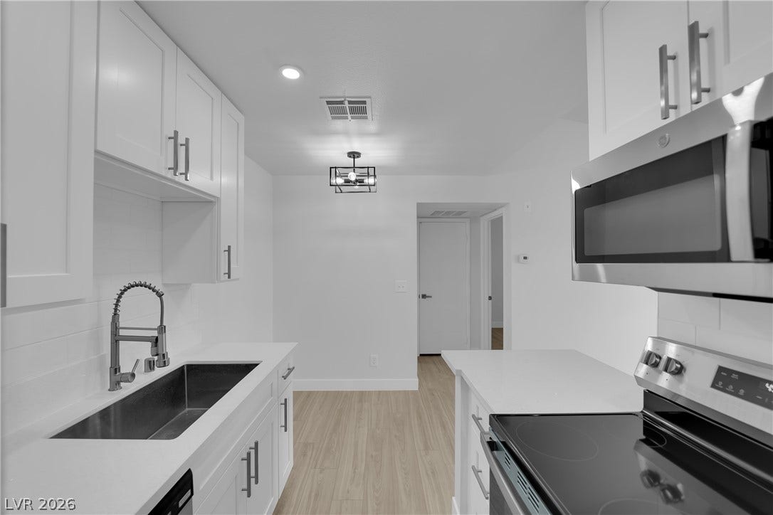 5111 Lindell Road, #202, Las Vegas, NV 89118 Crisp white cabinetry paired with modern stainless steel appliances defines this culinary space.