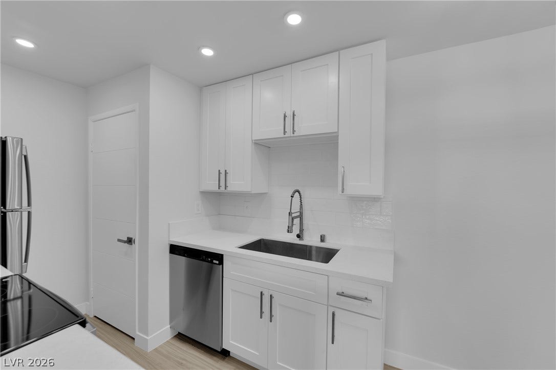 5111 Lindell Road, #202, Las Vegas, NV 89118 Crisp white cabinetry paired with modern stainless steel appliances creates a clean culinary workspace.