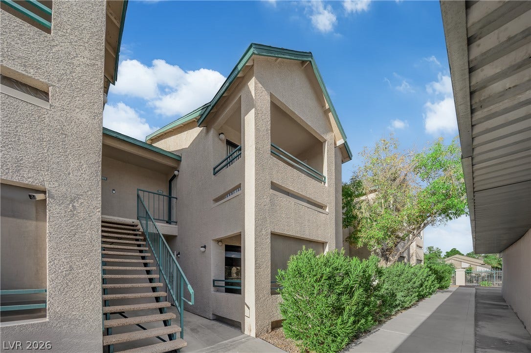 5111 Lindell Road, #202, Las Vegas, NV 89118 Stucco exteriors and concrete walkways define this multi-level residential complex.