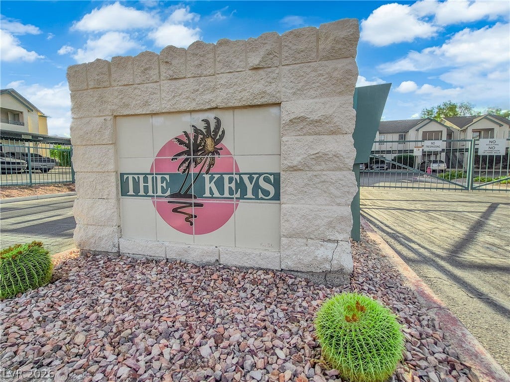 5111 Lindell Road, #202, Las Vegas, NV 89118 An inviting gated entrance features stone monument signage and desert landscaping.