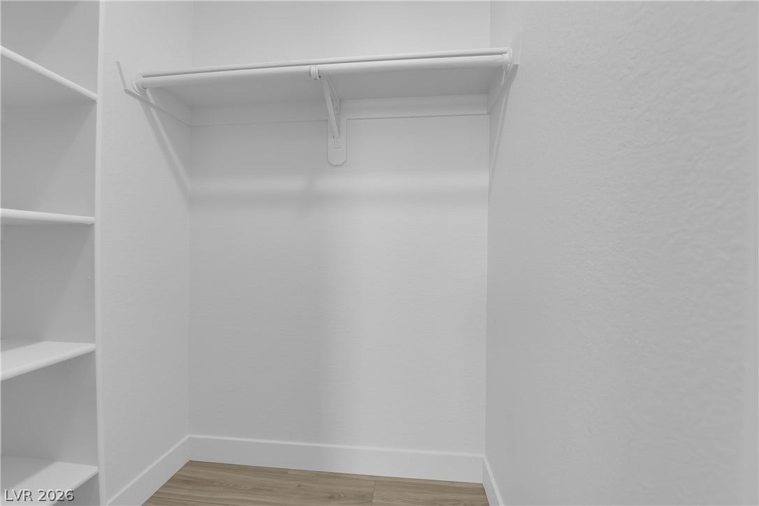 5111 Lindell Road, #202, Las Vegas, NV 89118 A functional closet space features built-in shelving, hanging rods, and wood-inspired flooring.