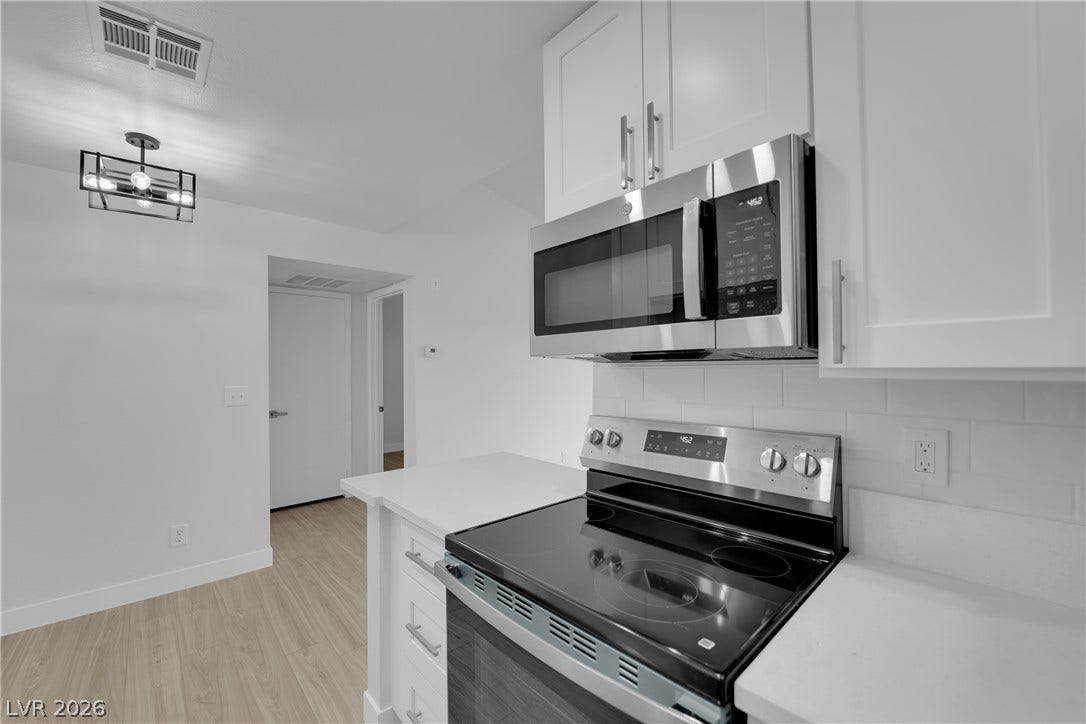 5111 Lindell Road, #202, Las Vegas, NV 89118 Gleaming stone countertops and stainless steel appliances anchor this modern culinary workspace.