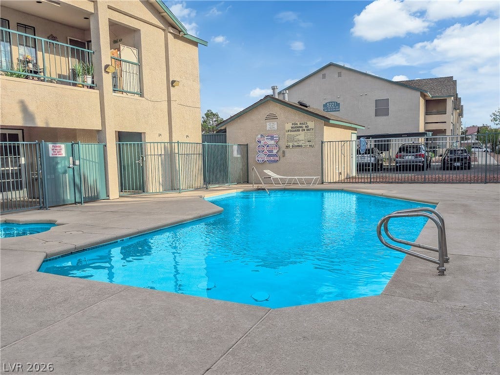 5111 Lindell Road, #202, Las Vegas, NV 89118 A sparkling blue community swimming pool is surrounded by a spacious concrete sundeck.