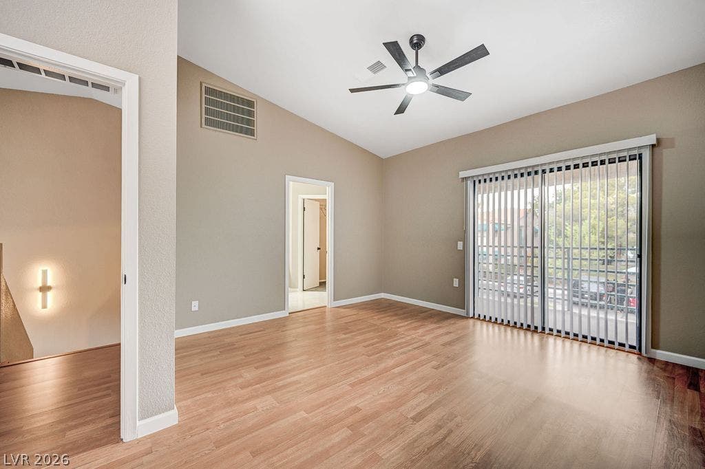 2191 Pinetop Lane, #104, Las Vegas, NV 89119 Vaulted ceilings and wood-style flooring elevate this comfortable living area.