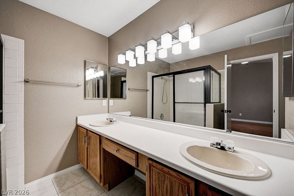 2191 Pinetop Lane, #104, Las Vegas, NV 89119 An expansive vanity counter and a glass-enclosed shower highlight this functional bathroom.