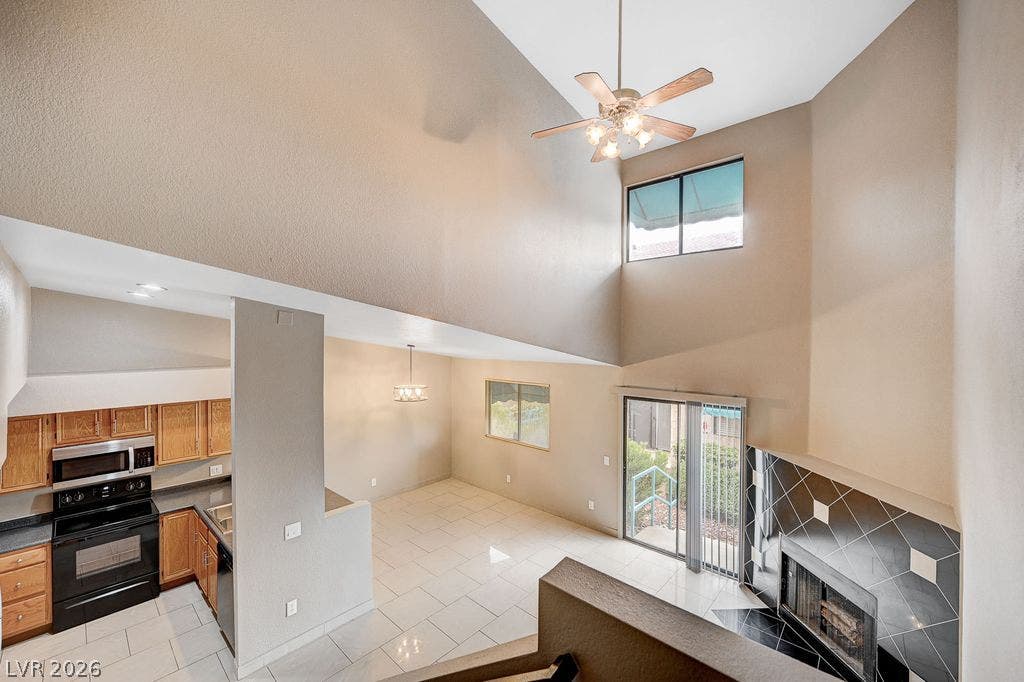 2191 Pinetop Lane, #104, Las Vegas, NV 89119 Dramatic vaulted ceilings and a sleek fireplace frame this spacious open-concept living area.