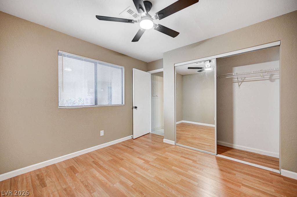2191 Pinetop Lane, #104, Las Vegas, NV 89119 Warm wood flooring and sliding mirrored closet doors define this comfortable bedroom space.