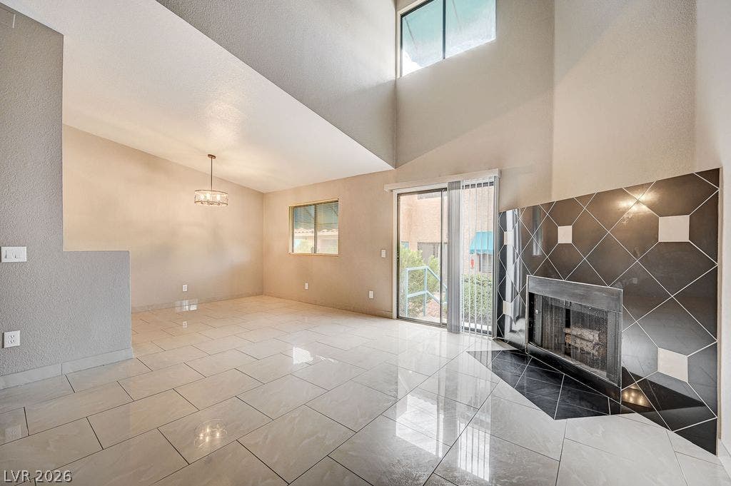 2191 Pinetop Lane, #104, Las Vegas, NV 89119 Towering ceilings and a tiled fireplace anchor this airy, open-concept living space.