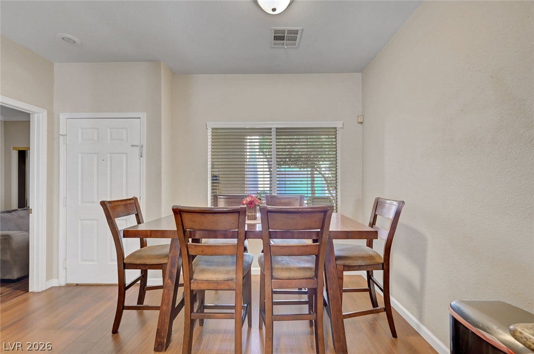 7450 S Eastern Avenue, #1064, Las Vegas, NV 89123 Smooth wood floors anchor this dining area illuminated by natural light through a wide window.