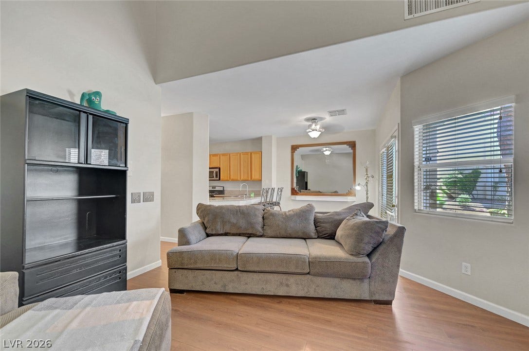 7450 S Eastern Avenue, #1064, Las Vegas, NV 89123 Vaulted ceilings and warm wood-look floors enhance this welcoming, open living space.