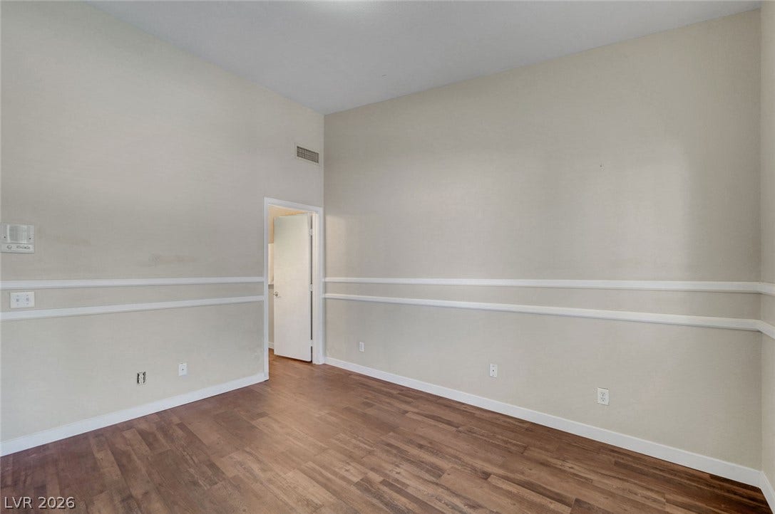 7450 S Eastern Avenue, #1064, Las Vegas, NV 89123 High ceilings and classic wall molding define this versatile living area with warm wood flooring.