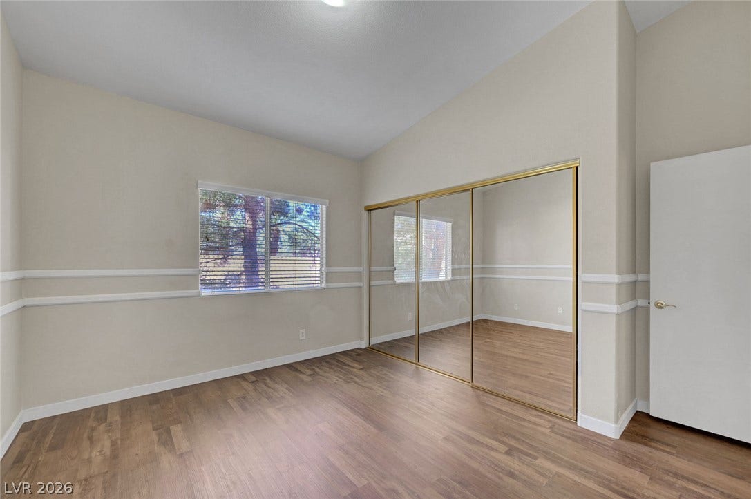7450 S Eastern Avenue, #1064, Las Vegas, NV 89123 Vaulted ceilings and warm wood floors define this versatile space featuring sliding mirrored closet doors.