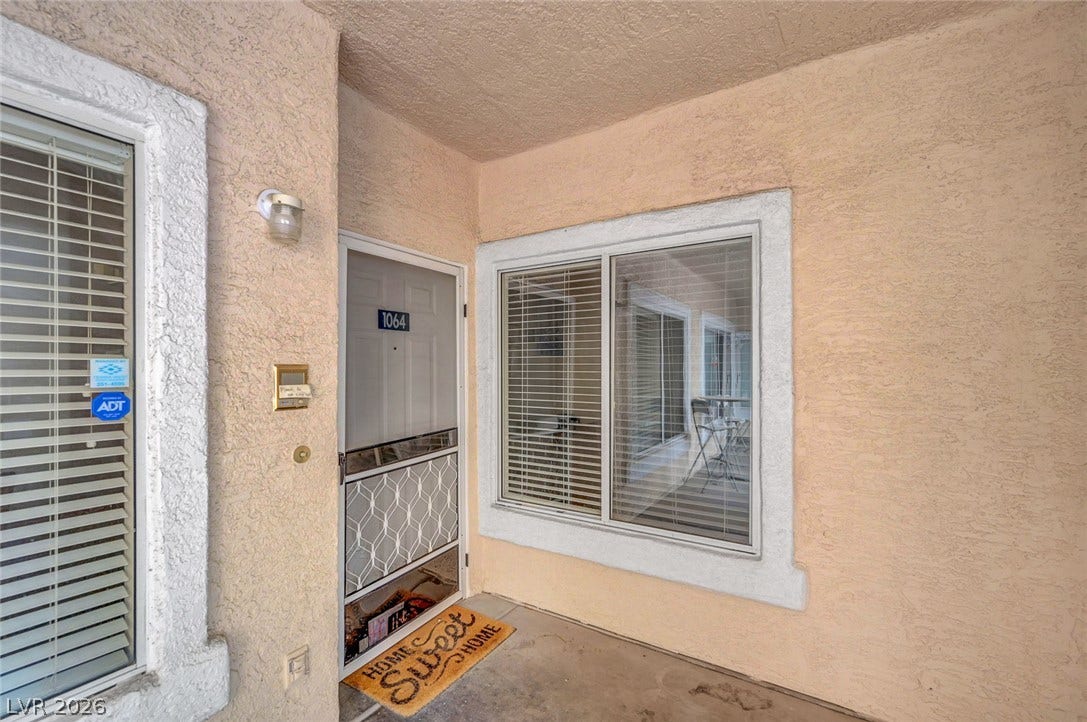 7450 S Eastern Avenue, #1064, Las Vegas, NV 89123 Textured stucco walls and a sheltered concrete entryway welcome residents home.