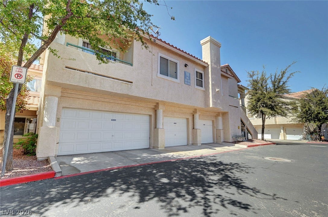 7450 S Eastern Avenue, #1064, Las Vegas, NV 89123 Multi-car garages sit beneath upper-level living spaces framed by classic stucco exterior walls.