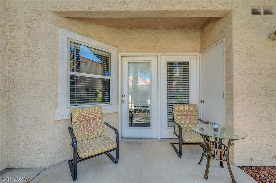 7450 S Eastern Avenue, #1064, Las Vegas, NV 89123 A sheltered concrete patio offers a private outdoor retreat framed by stucco walls.