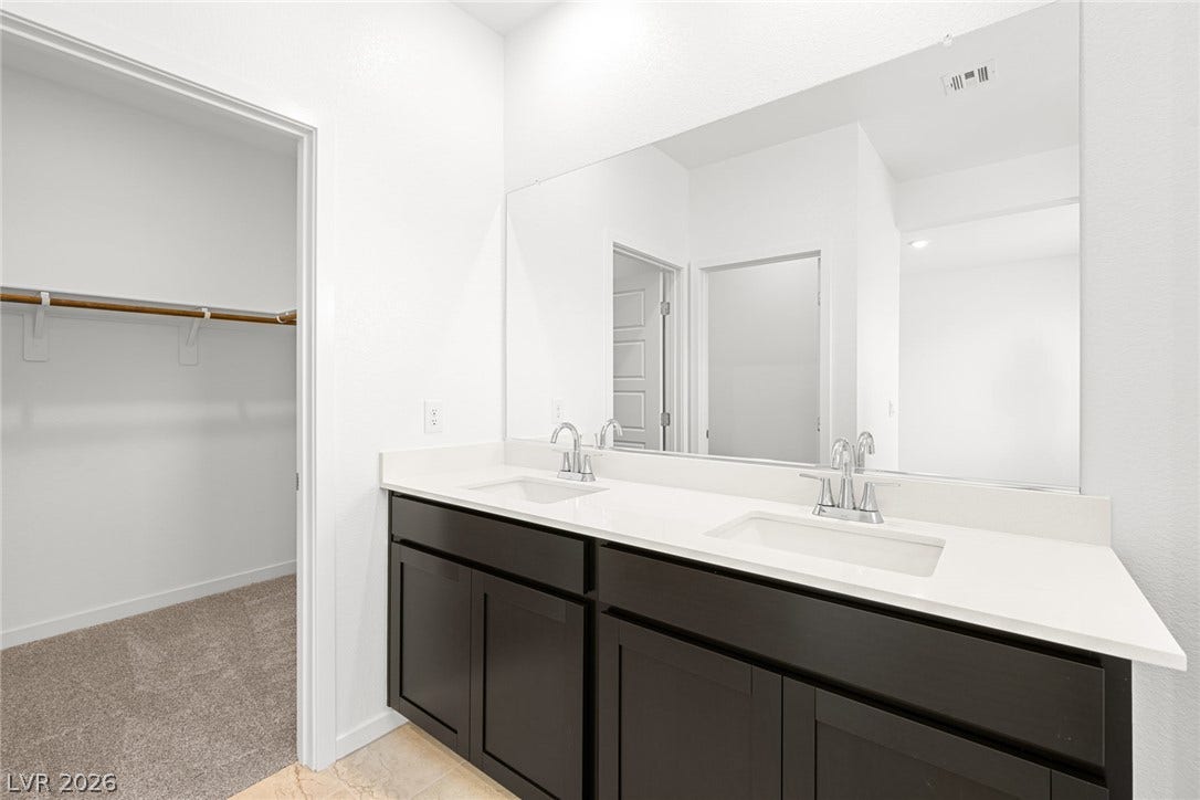 9568 Sagebrush Grove Street, Las Vegas, NV 89178 Clean lines and a spacious dual vanity highlight this modern bathroom design.
