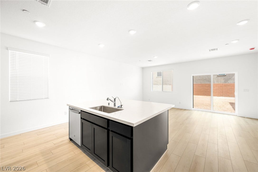 9568 Sagebrush Grove Street, Las Vegas, NV 89178 An open floorplan connects the central kitchen island to the bright dining and living spaces.