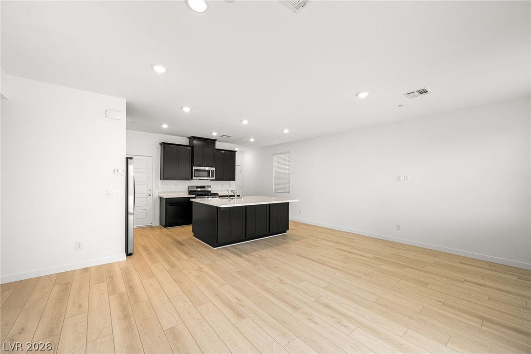 9568 Sagebrush Grove Street, Las Vegas, NV 89178 Clean lines and smooth flooring define this generous, open-concept living area and kitchen.