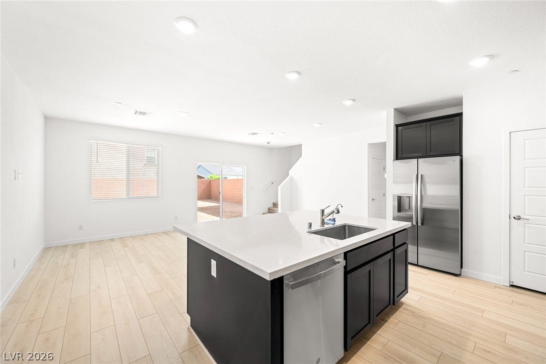 9568 Sagebrush Grove Street, Las Vegas, NV 89178 An open floorplan seamlessly connects the modern kitchen to the adjacent living spaces.