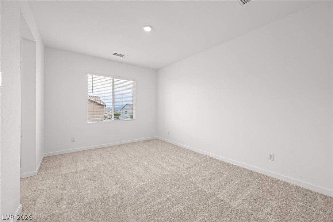 9568 Sagebrush Grove Street, Las Vegas, NV 89178 Plush carpeting and recessed lighting define this versatile, minimalist interior space.