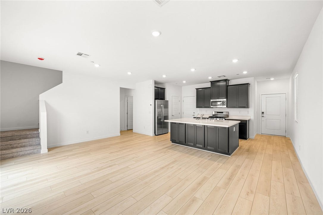9568 Sagebrush Grove Street, Las Vegas, NV 89178 An open floorplan seamlessly connects the airy living area to a modern kitchen design.