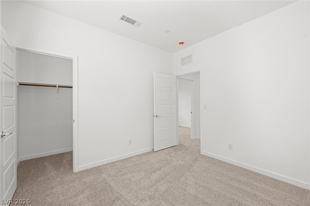9568 Sagebrush Grove Street, Las Vegas, NV 89178 Soft carpeting pairs with neutral walls in this versatile secondary bedroom featuring a closet.