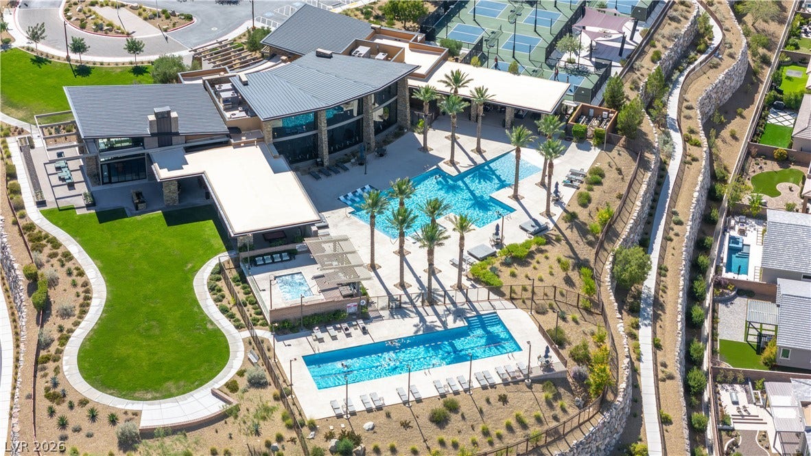 2999 The Peaks Lane, Las Vegas, NV 89138 16,000 sq ft Clubhouse with a 3,000 sq ft pool, 1,600 sq ft lap pool, 800 sq ft spa, fitness center, multipurpose rooms, 4 lighted pickleball courts, volleyball court, great room, event lawn space, outdoor fire terrace with Strip view, ping pong / billiards terrace and picnic area.