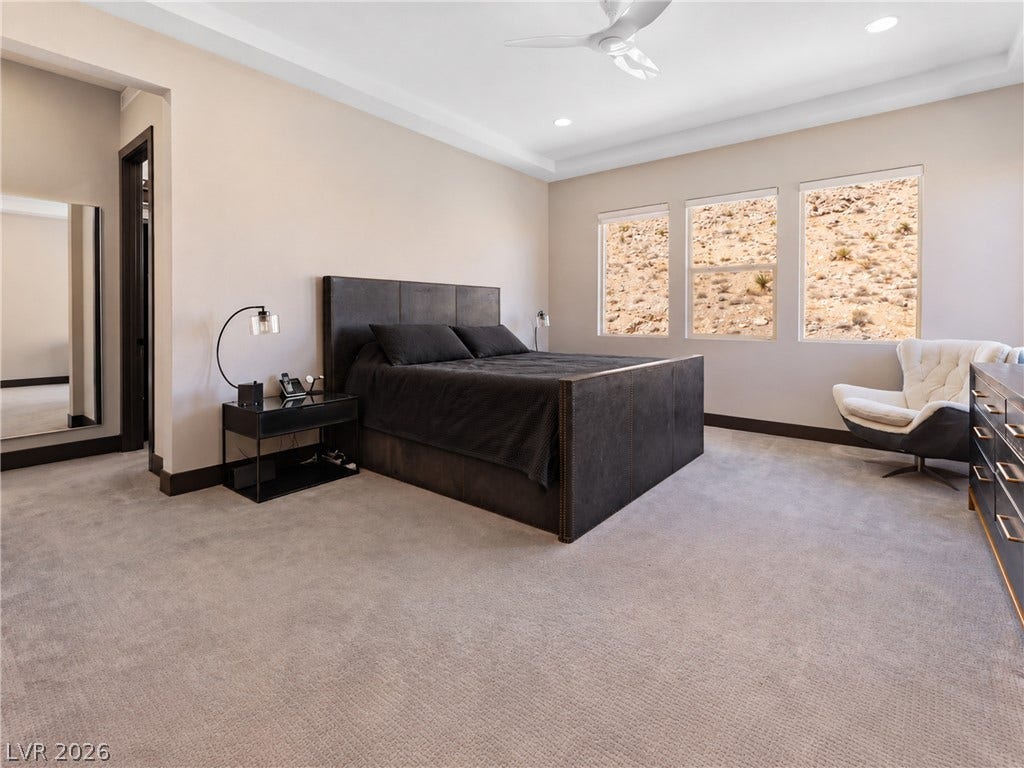 2999 The Peaks Lane, Las Vegas, NV 89138 Upstairs Primary bedroom (5) with large sitting area/gym separated by beautiful double sided fireplace. Huge Custom walk-in closet and highly upgraded primary bathroom and private balcony.