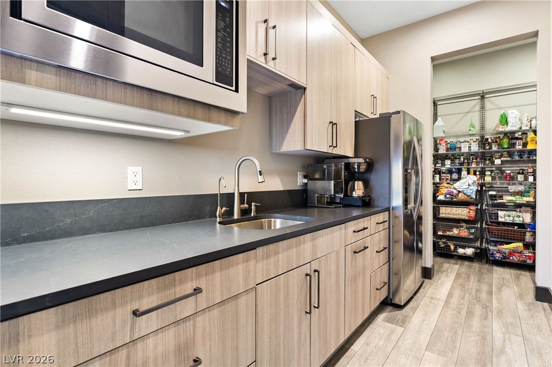 2999 The Peaks Lane, Las Vegas, NV 89138 Butler pantry with refrigerator, microwave and sink connects seamlessly to a spacious walk-in storage area.