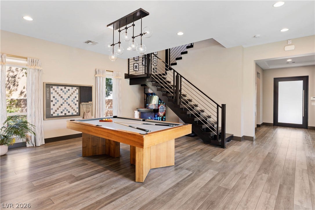 2999 The Peaks Lane, Las Vegas, NV 89138 Spacious flex space/ game room and a modern floating staircase and front door.