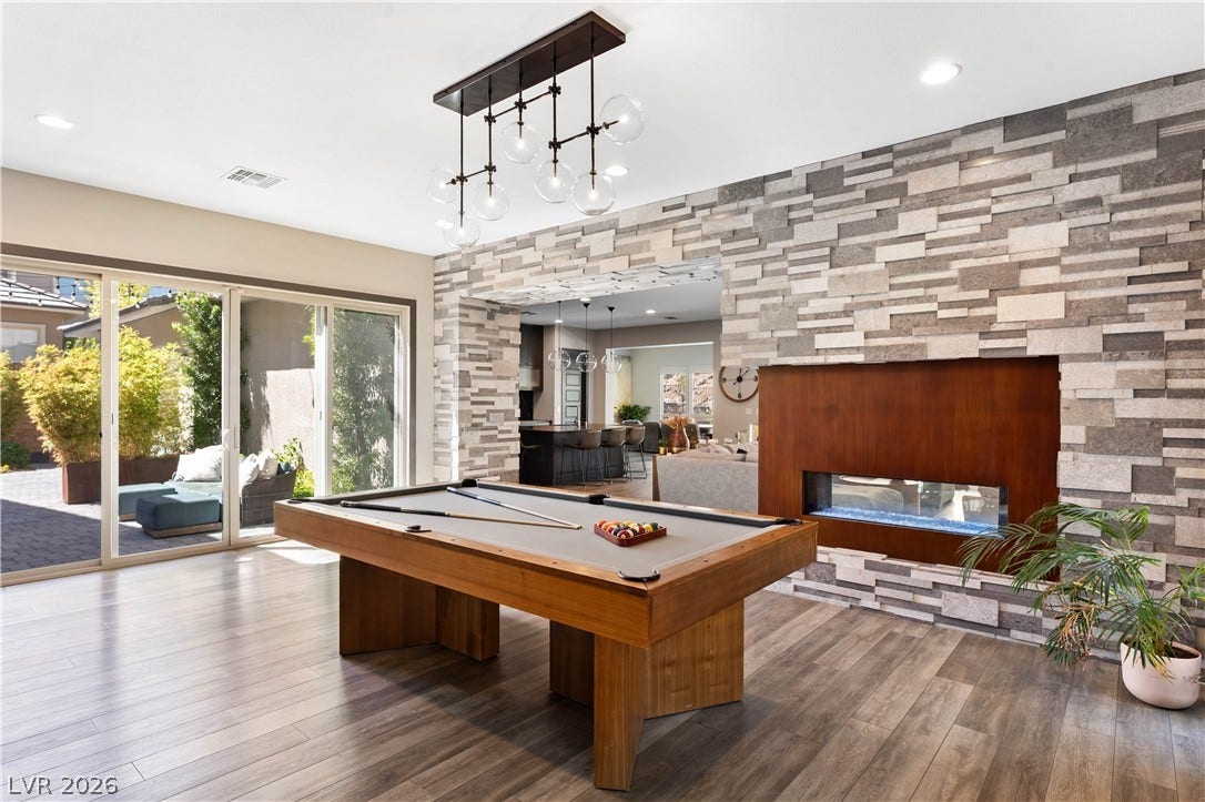 2999 The Peaks Lane, Las Vegas, NV 89138 Sliding glass doors open to the private court yard off the flex space/ game room for seamless indoor and outdoor entertaining