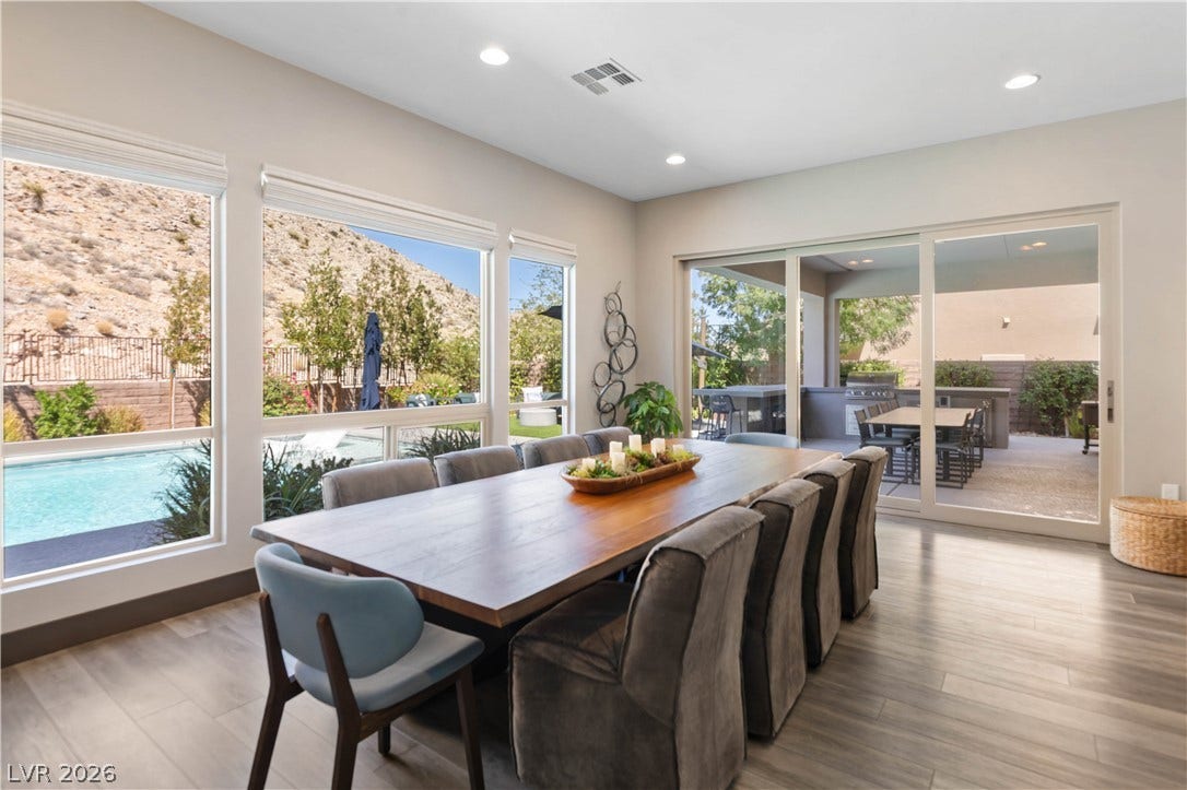 2999 The Peaks Lane, Las Vegas, NV 89138 Generous windows and sliding doors seamlessly connect this refined dining space to the outdoor covered patio and outdoor kitchen.