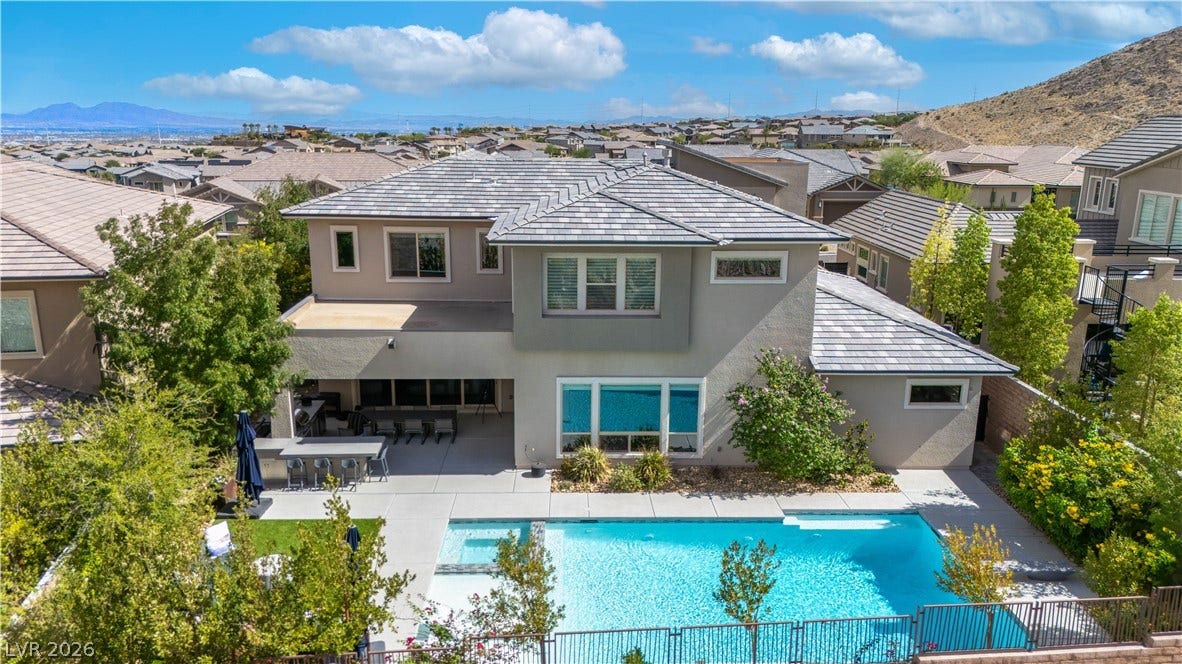 2999 The Peaks Lane, Las Vegas, NV 89138 An inviting backyard oasis centers around a sparkling swimming pool under clear blue skies.