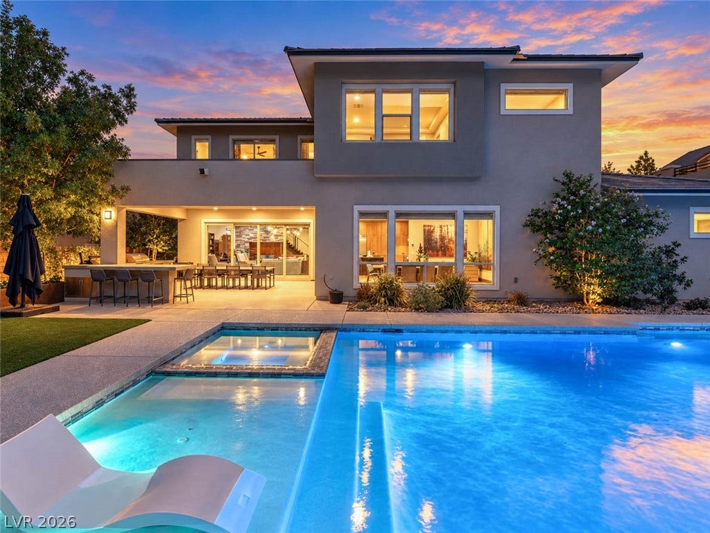 2999 The Peaks Lane, Las Vegas, NV 89138 A sparkling geometric pool anchors this modern estate backyard framed by custom architectural glazing.