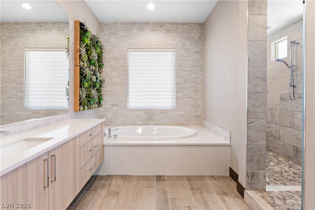 2999 The Peaks Lane, Las Vegas, NV 89138 Upstairs Primary bedroom (5)with large sitting area/gym separated by beautiful double sided fireplace. Huge Custom walk-in closet and highly upgraded primary bathroom with soaking tub and private balcony.