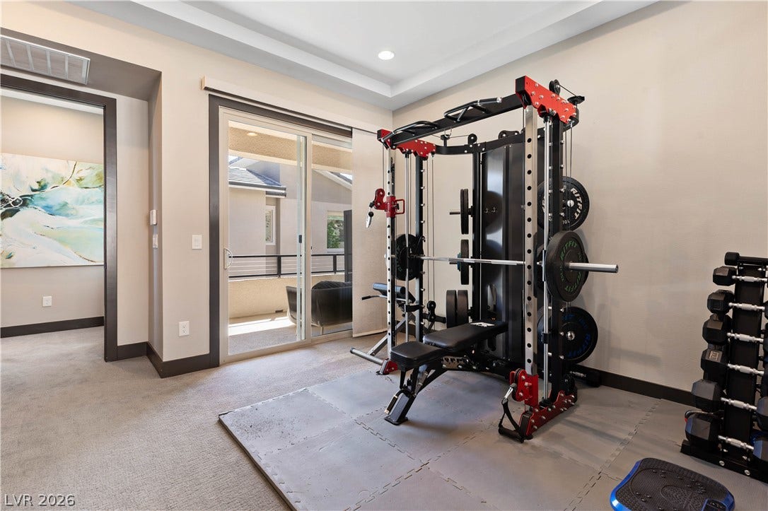 2999 The Peaks Lane, Las Vegas, NV 89138 Upstairs Primary bedroom (5)with large sitting area/gym separated by beautiful double sided fireplace. Huge Custom walk-in closet and highly upgraded primary bathroom and private balcony.