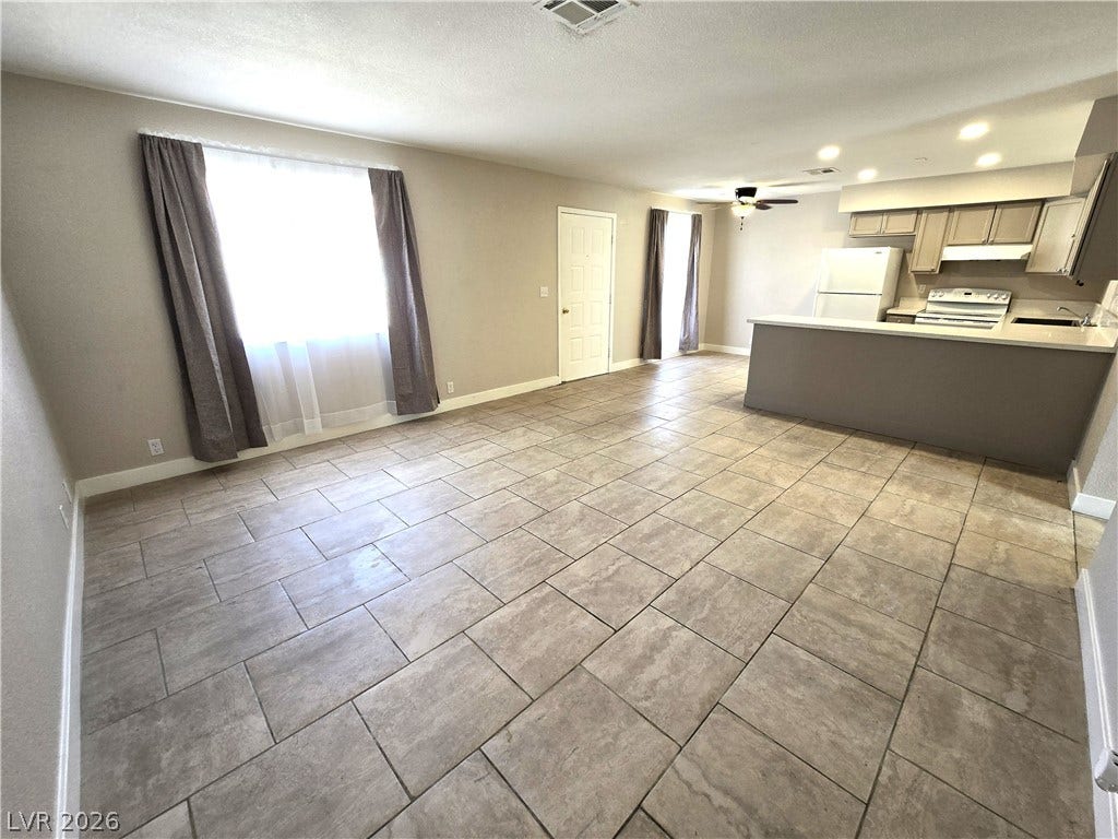 4300 N Lamont Street, #291, Las Vegas, NV 89115 An open floorplan seamlessly connects the tiled living space with the kitchen area.
