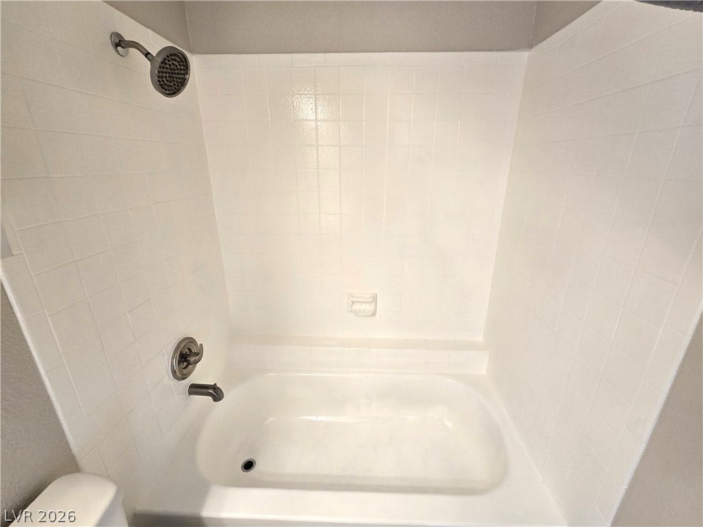 4300 N Lamont Street, #291, Las Vegas, NV 89115 A classic bathtub and shower combination features pristine white tile surrounds.