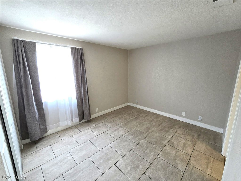 4300 N Lamont Street, #291, Las Vegas, NV 89115 Durable tile flooring highlights this versatile secondary bedroom space.