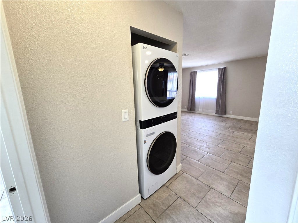 4300 N Lamont Street, #291, Las Vegas, NV 89115 Tiled flooring flows through the living areas adjacent to a built-in laundry niche.