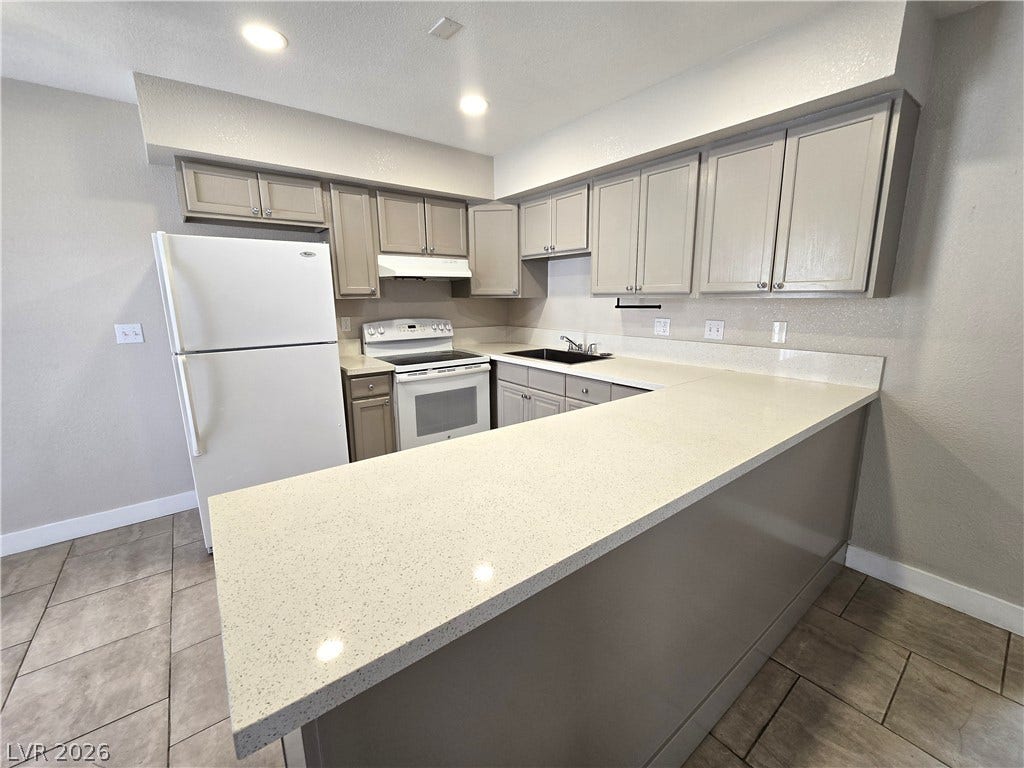 4300 N Lamont Street, #291, Las Vegas, NV 89115 Ample stone countertops and modern cabinetry highlight this efficiently designed kitchen.