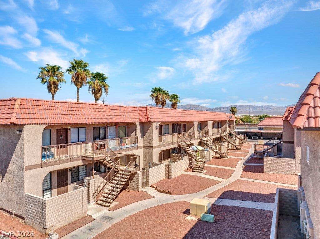 4300 N Lamont Street, #291, Las Vegas, NV 89115 Multi-level residential structures feature classic tile roofing and private balconies under clear desert skies.