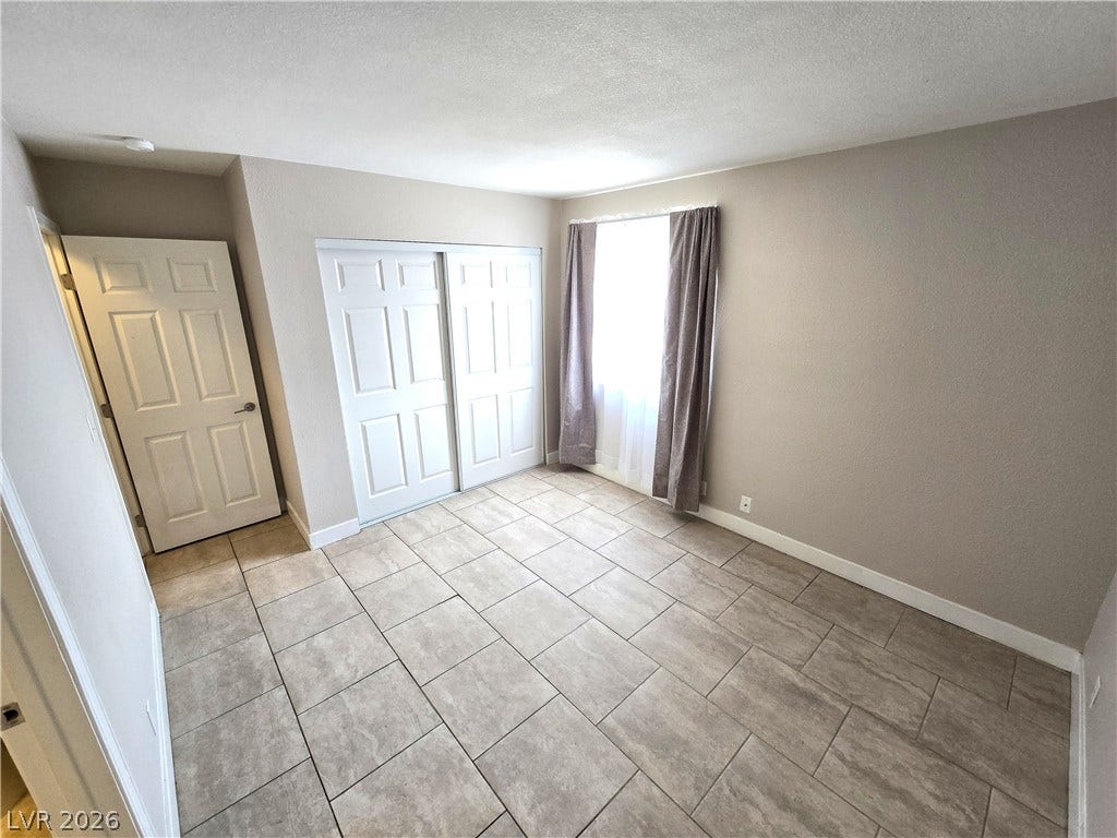 4300 N Lamont Street, #291, Las Vegas, NV 89115 Tiled flooring and a large sliding closet door define this versatile room.