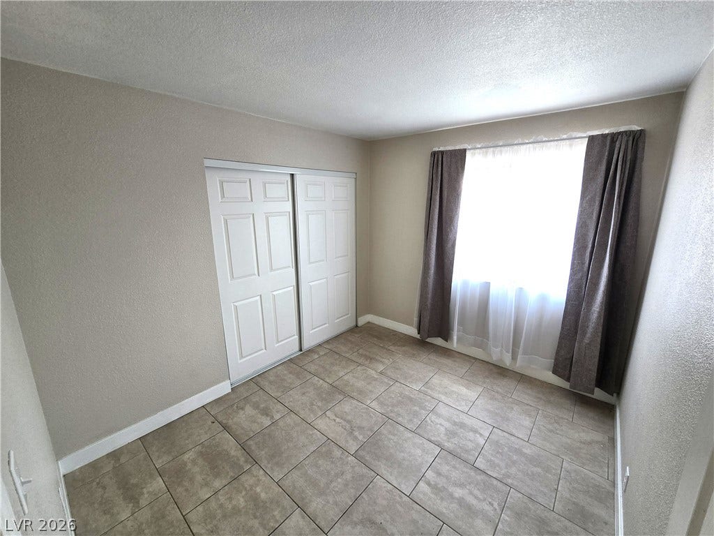 4300 N Lamont Street, #291, Las Vegas, NV 89115 Durable tile flooring highlights this versatile bedroom space complete with a sliding closet door setup.