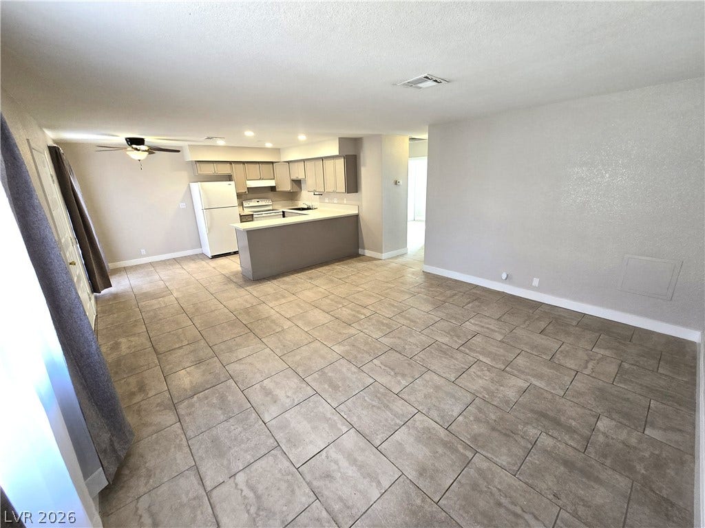 4300 N Lamont Street, #291, Las Vegas, NV 89115 An open layout flows seamlessly from the tile-floored living area into the kitchen.